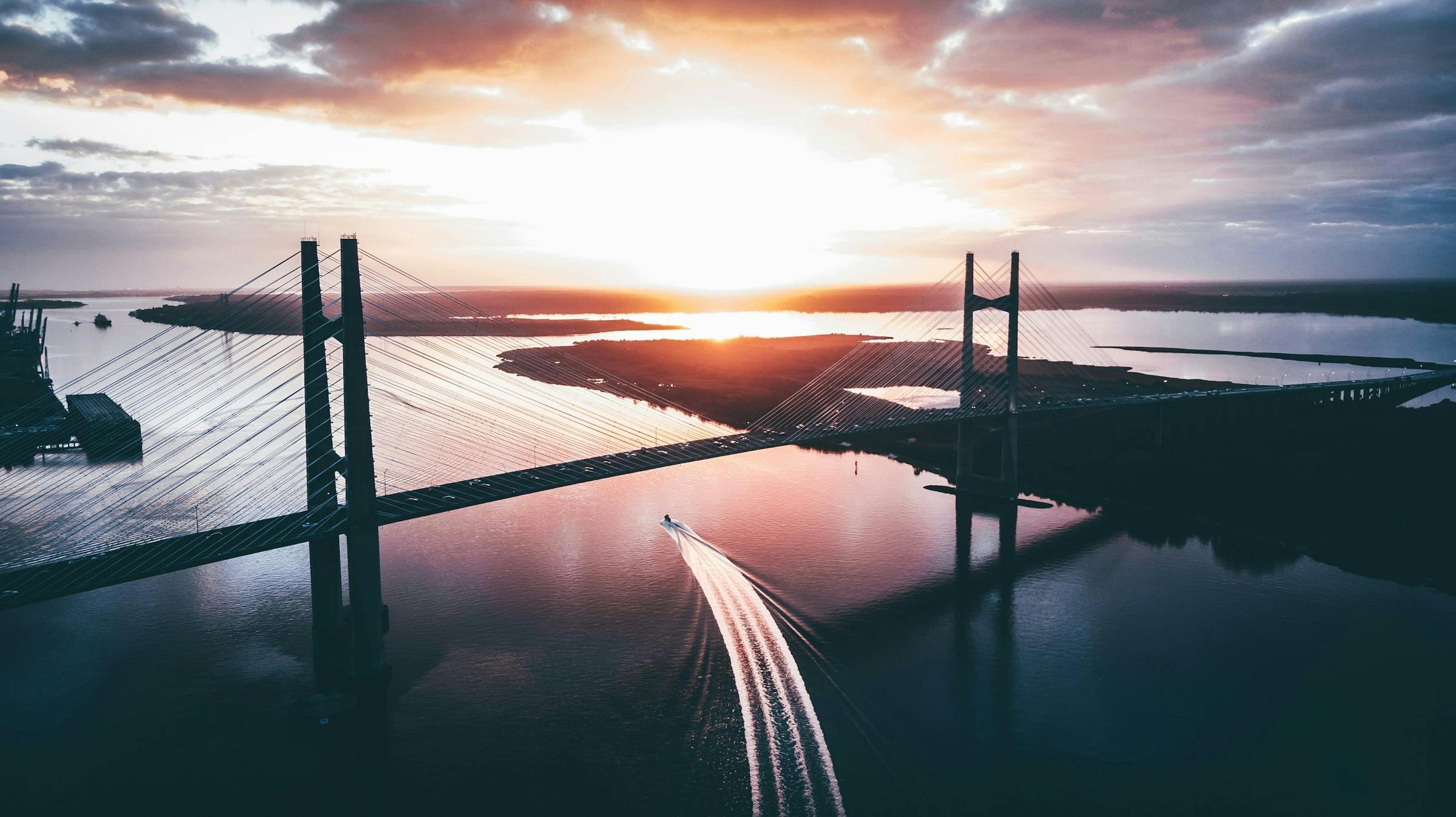 A bridge over water with a boat in the water